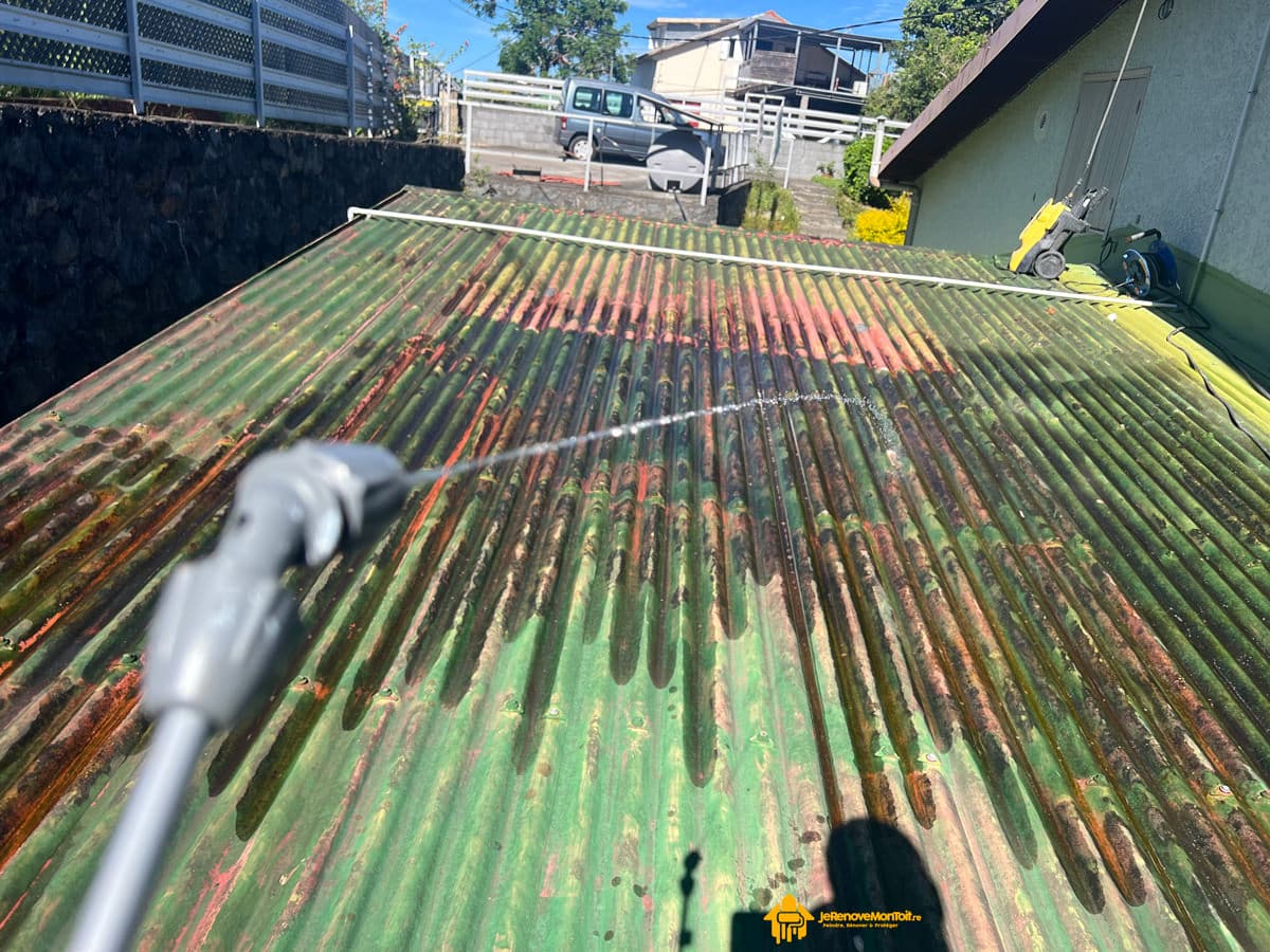 Application d'un nettoyant multiusage via un pulvérisateur sur une toiture sale à la Réunion